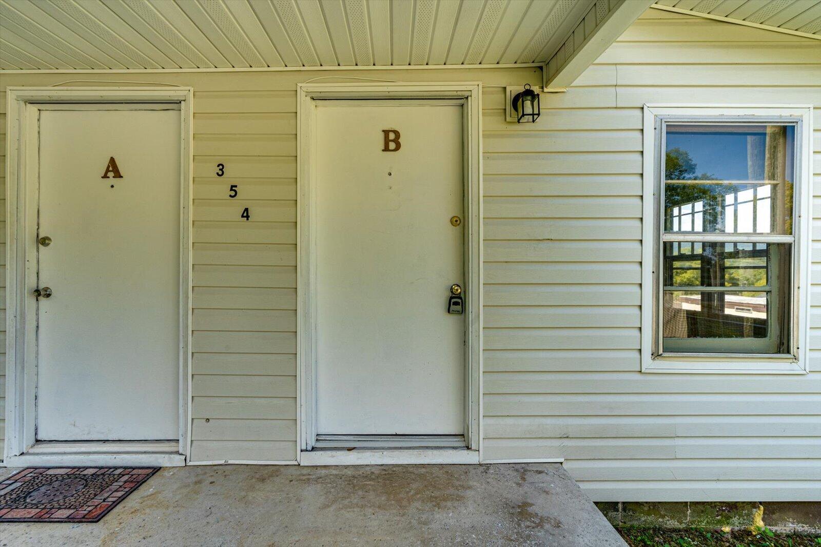 Two labeled entrances, A and B, beside the number 354 on a light-sided building.
