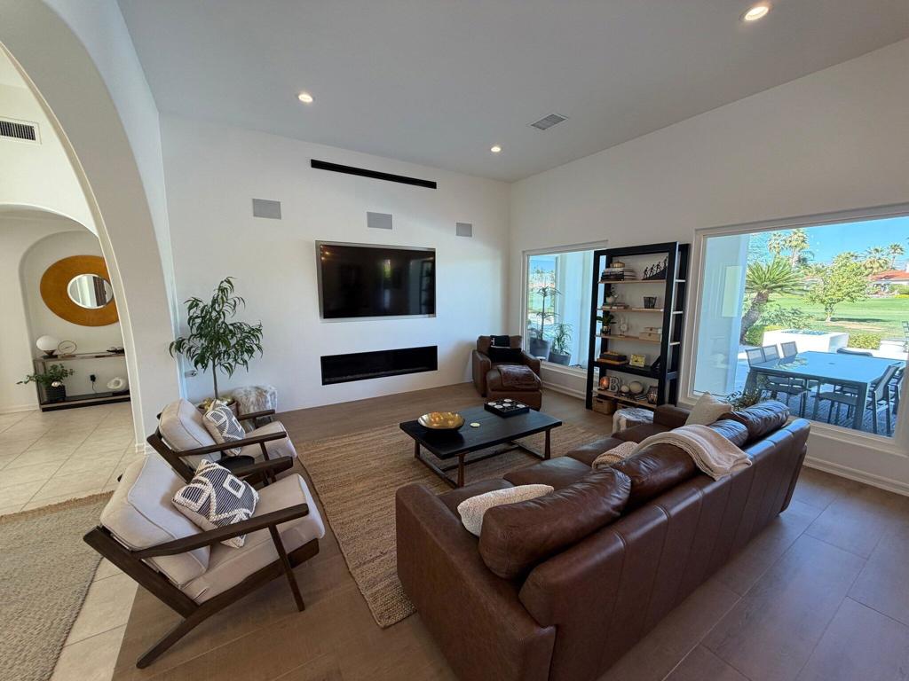 Living room with leather seating, a modern fireplace, and sliding doors to the patio.