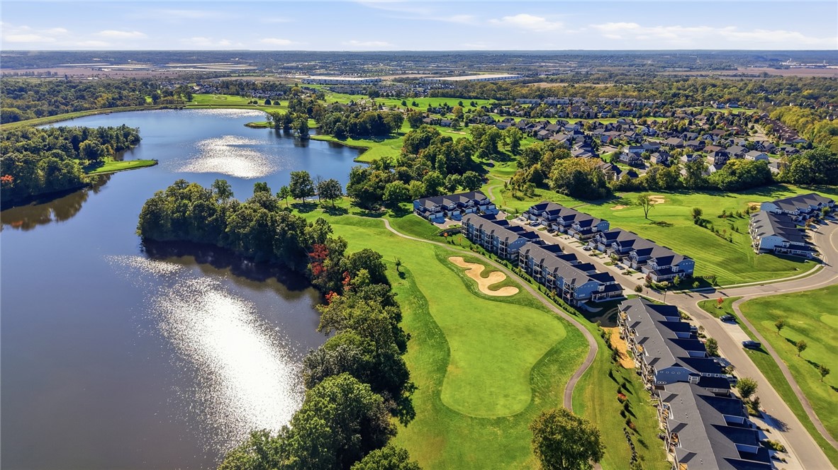 Aerial view of a lakeside residential community beside a golf course.