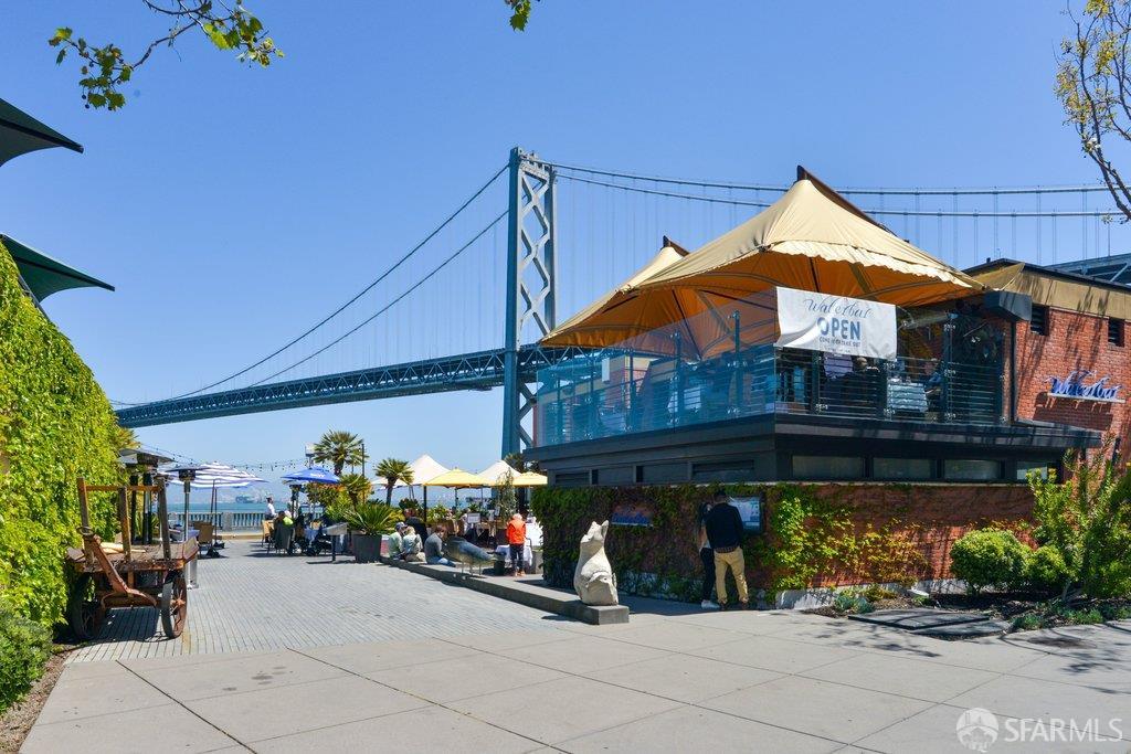 Waterbar waterfront restaurant beneath the Bay Bridge, with outdoor dining terraces and umbrellas.