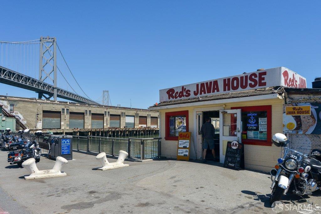 Red's Java House beside the waterfront, with the Bay Bridge behind it and motorcycles parked outside.