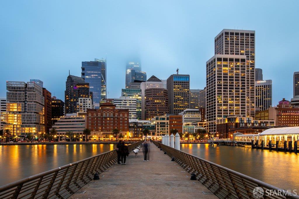 San Francisco skyline and waterfront viewed from a pier at dusk.