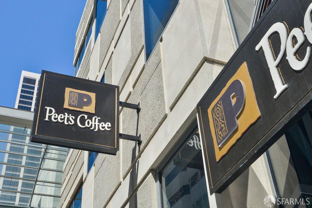 Peet’s Coffee storefront signs on a modern building beneath a clear blue sky.