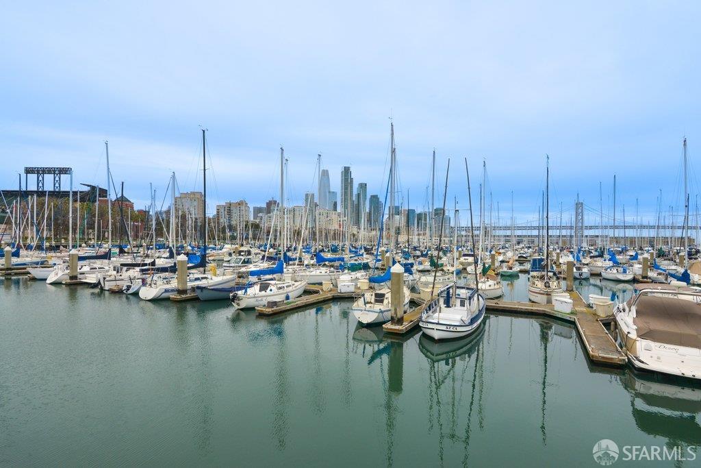 San Francisco marina with sailboats, downtown skyline, and a bridge in the distance.