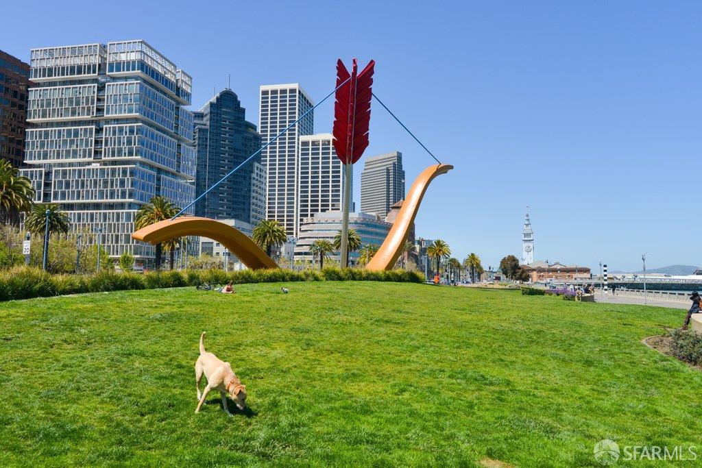 San Francisco park with the Cupid’s Span sculpture, grassy lawn, and downtown skyline.