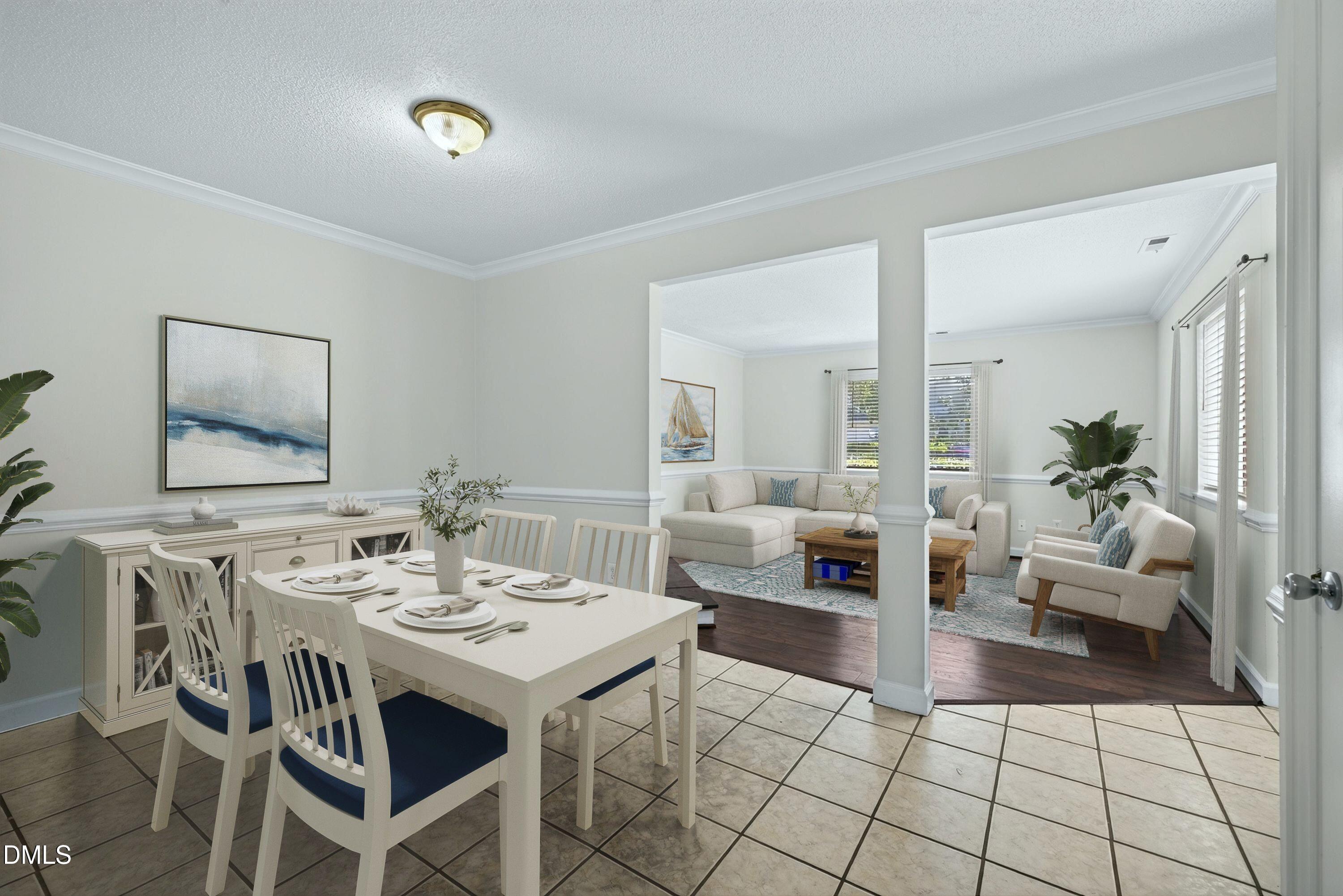 Dining area with a set white table opens into a living room with a cream sectional and armchairs.