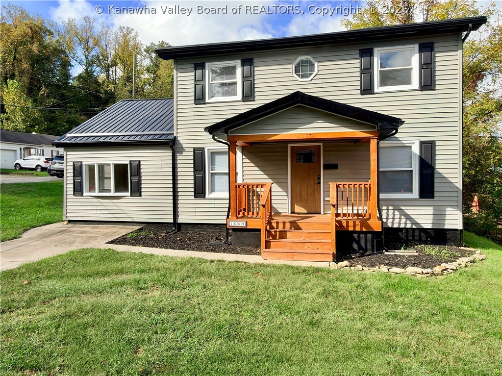 Two-story house with black shutters and a prominent wooden front porch.
