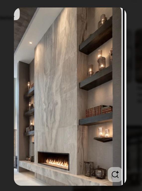 Tall stone fireplace with a long gas firebox and illuminated built-in shelves.