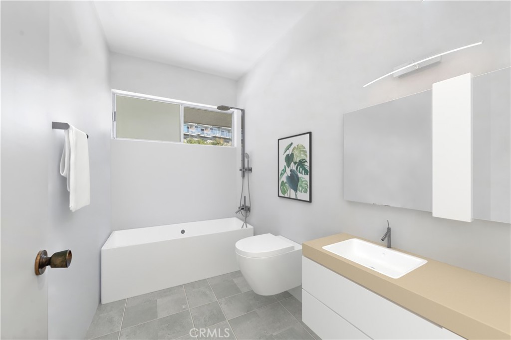 Modern bathroom with a bathtub, wall-mounted toilet, and floating vanity with a beige countertop.