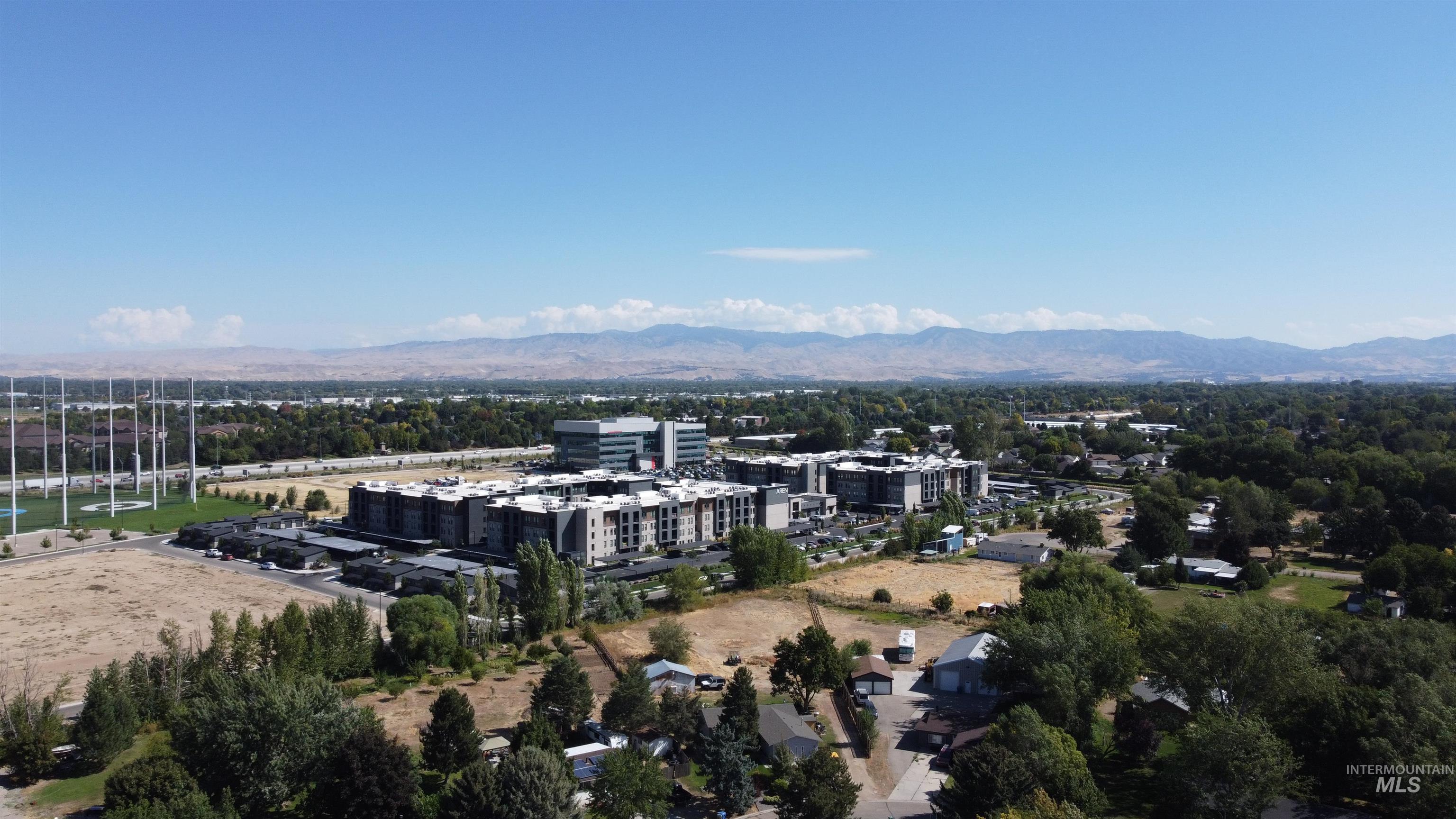 Aerial view of an apartment complex with mountains in the distance.
