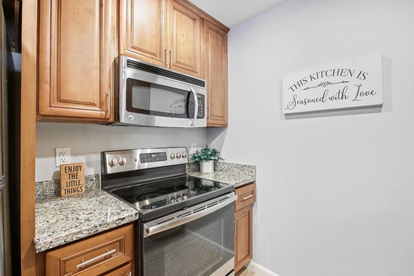 Kitchen with wood cabinets, granite counters, and stainless steel appliances.