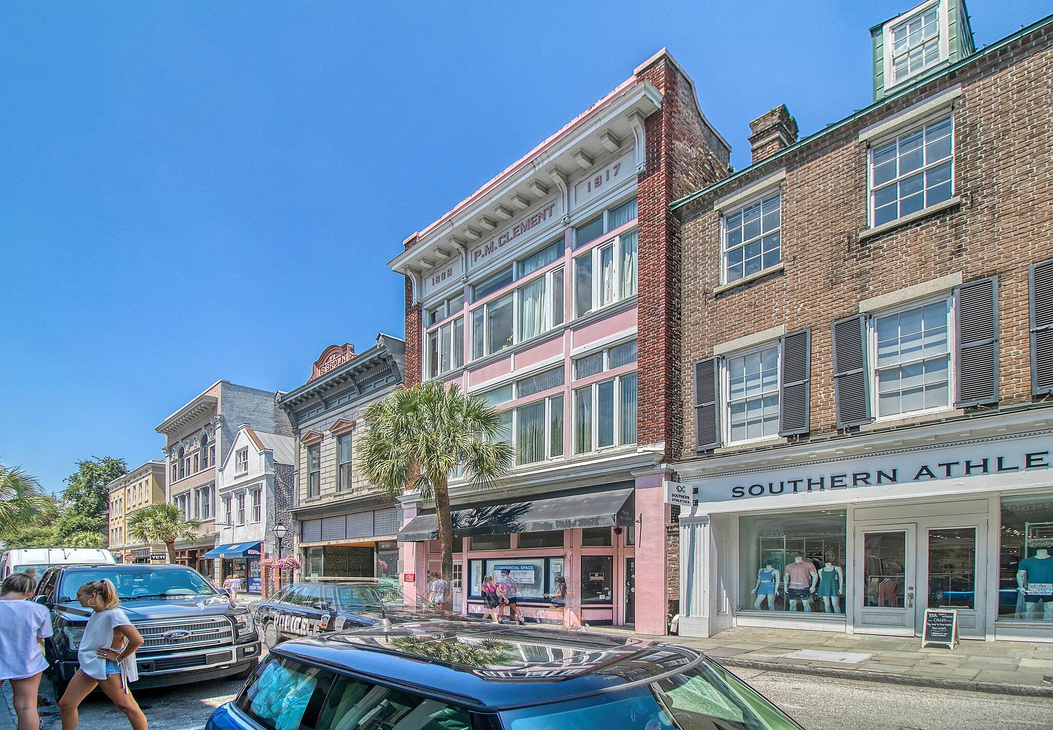 Historic King Street building with a pink facade, large windows, and ground-floor storefronts.