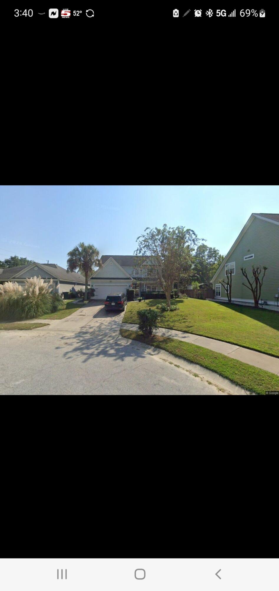 Two-story suburban home with a front-facing garage, driveway, and lawn.