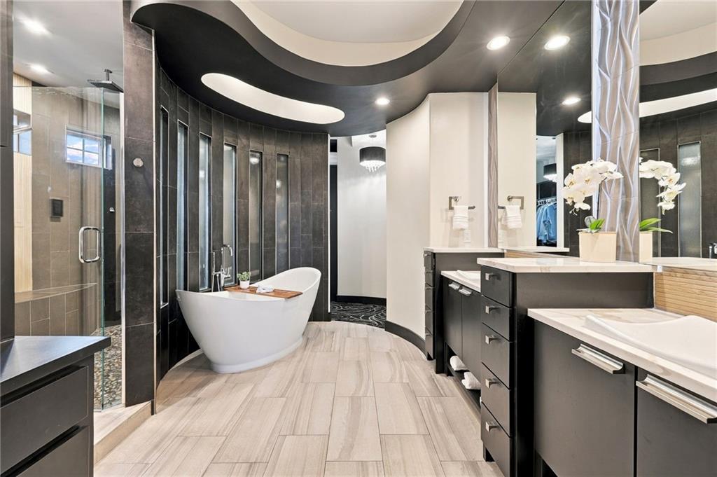 Modern bathroom with a freestanding tub, glass shower, and double vanity.