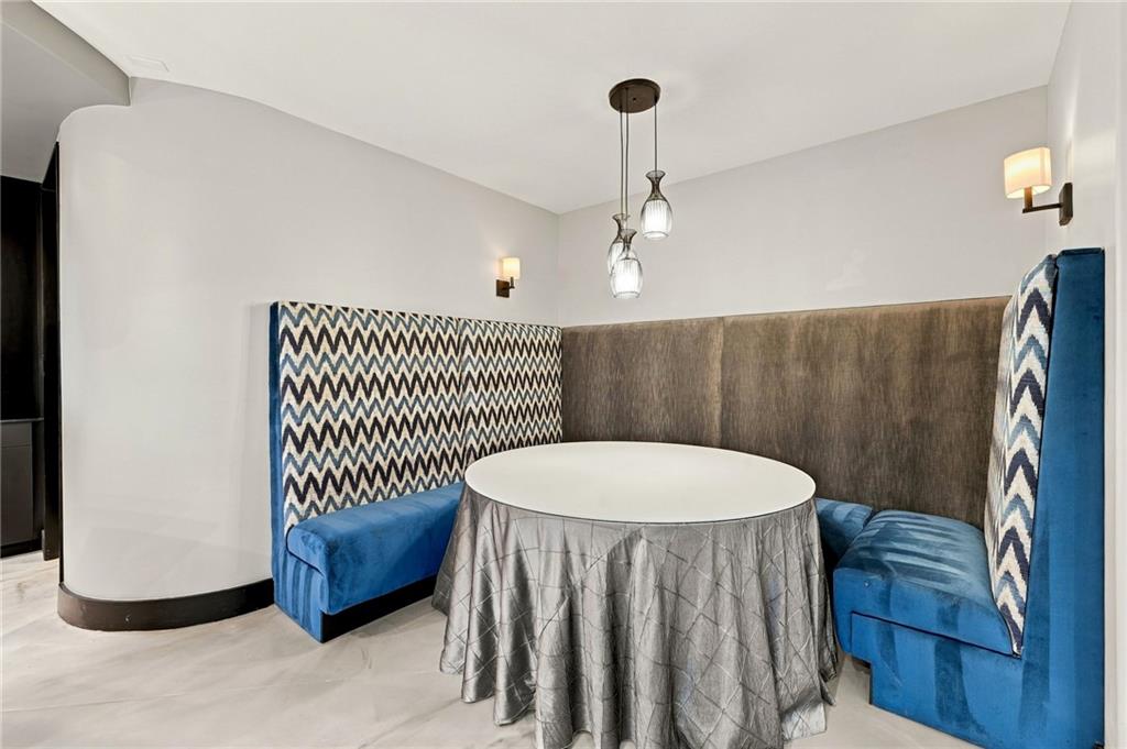 Dining nook with a round table and blue built-in banquette seating.