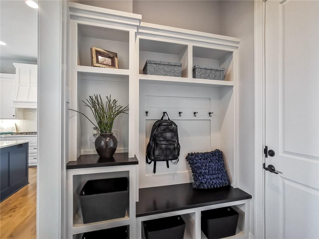 Entryway built-in cubbies and bench with a backpack, storage bins, and decorative accents.