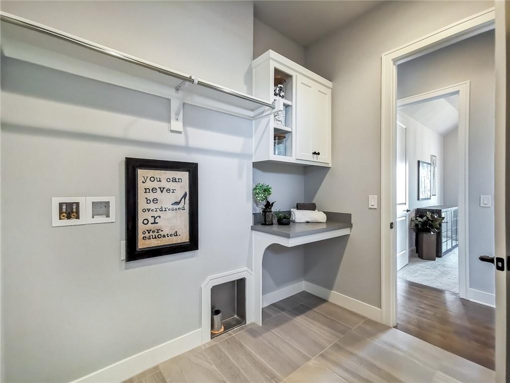 Built-in dressing area with a hanging rod, white cabinets, and a small counter nook.