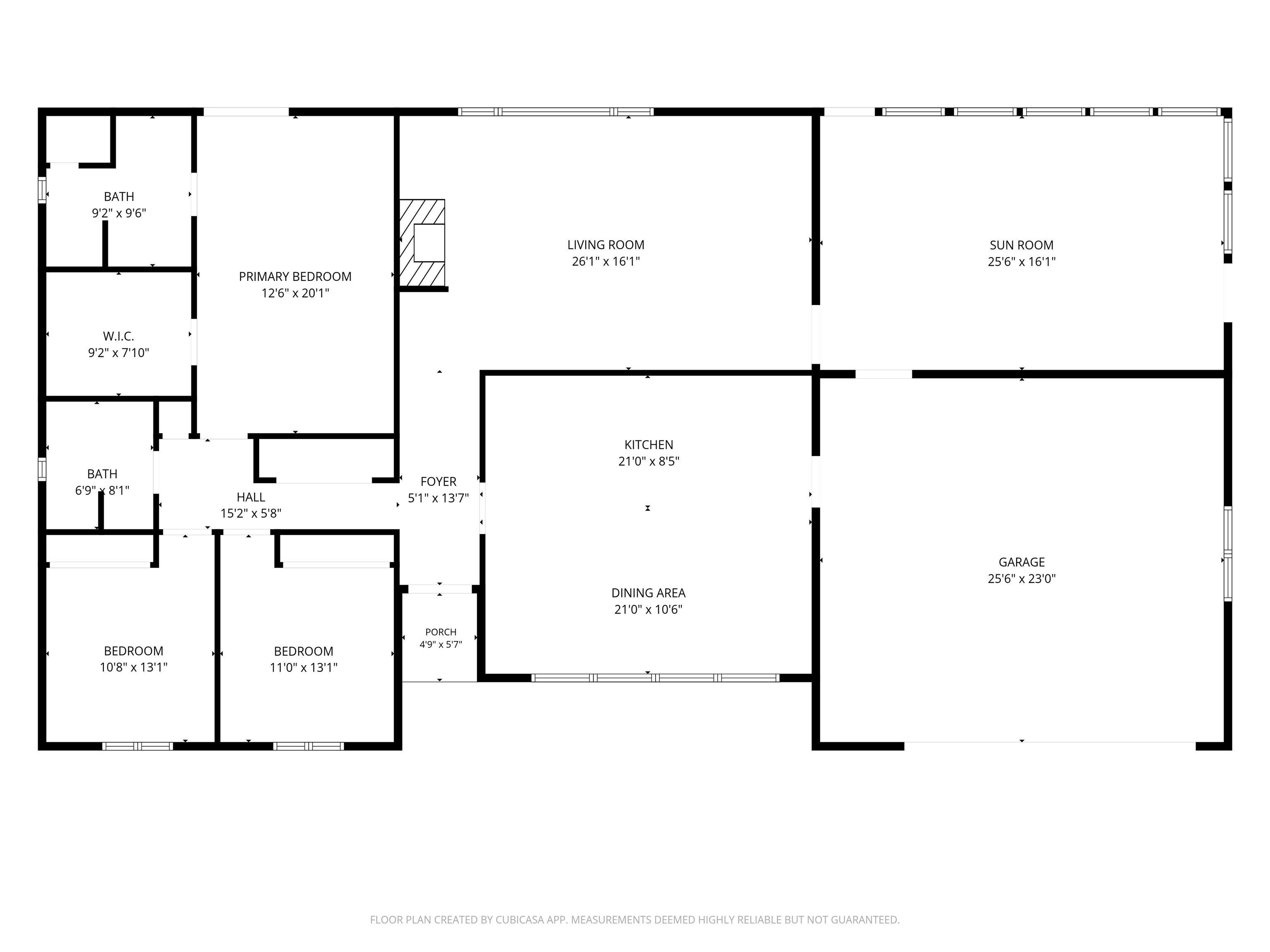 Floor plan showing three bedrooms, two baths, living room, sunroom, kitchen, dining area, and garage.