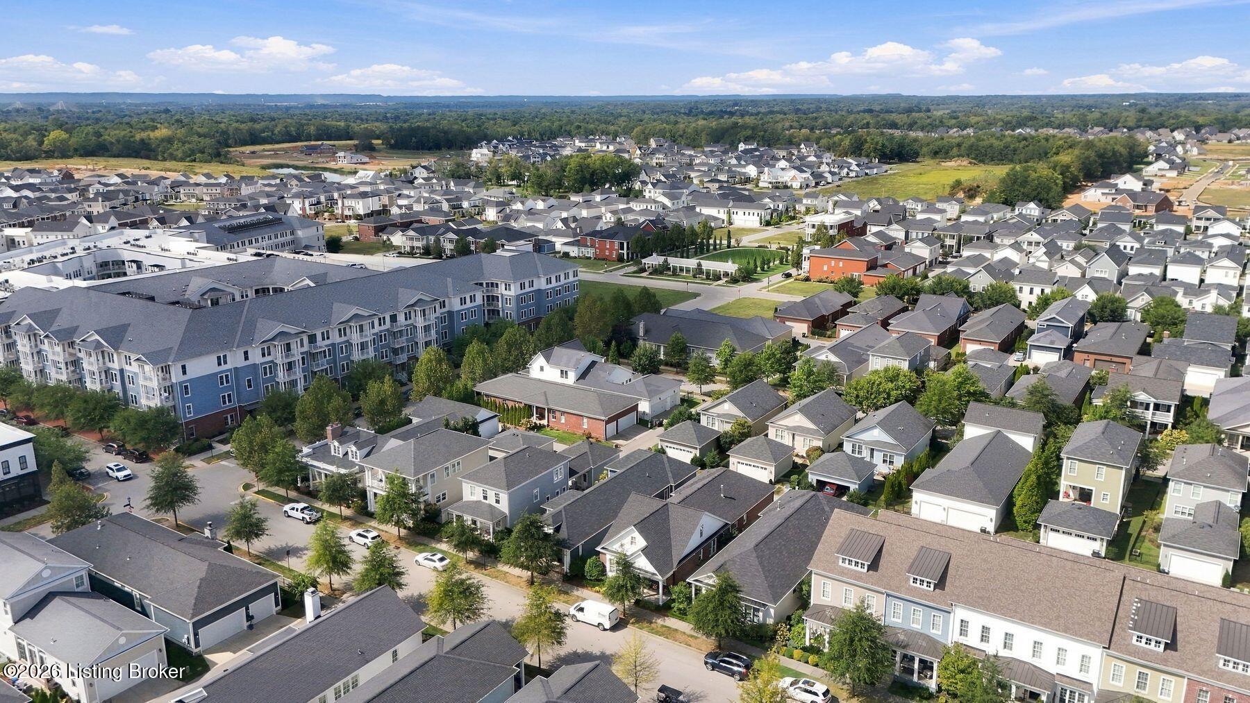 Aerial view of a residential neighborhood with rows of homes and a large apartment building.