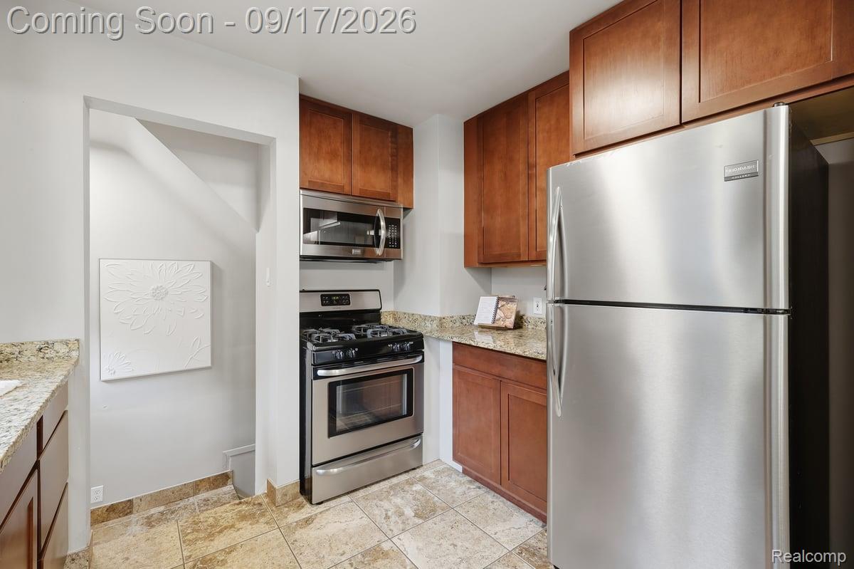 Kitchen with wood cabinets, granite countertops, and stainless steel appliances.
