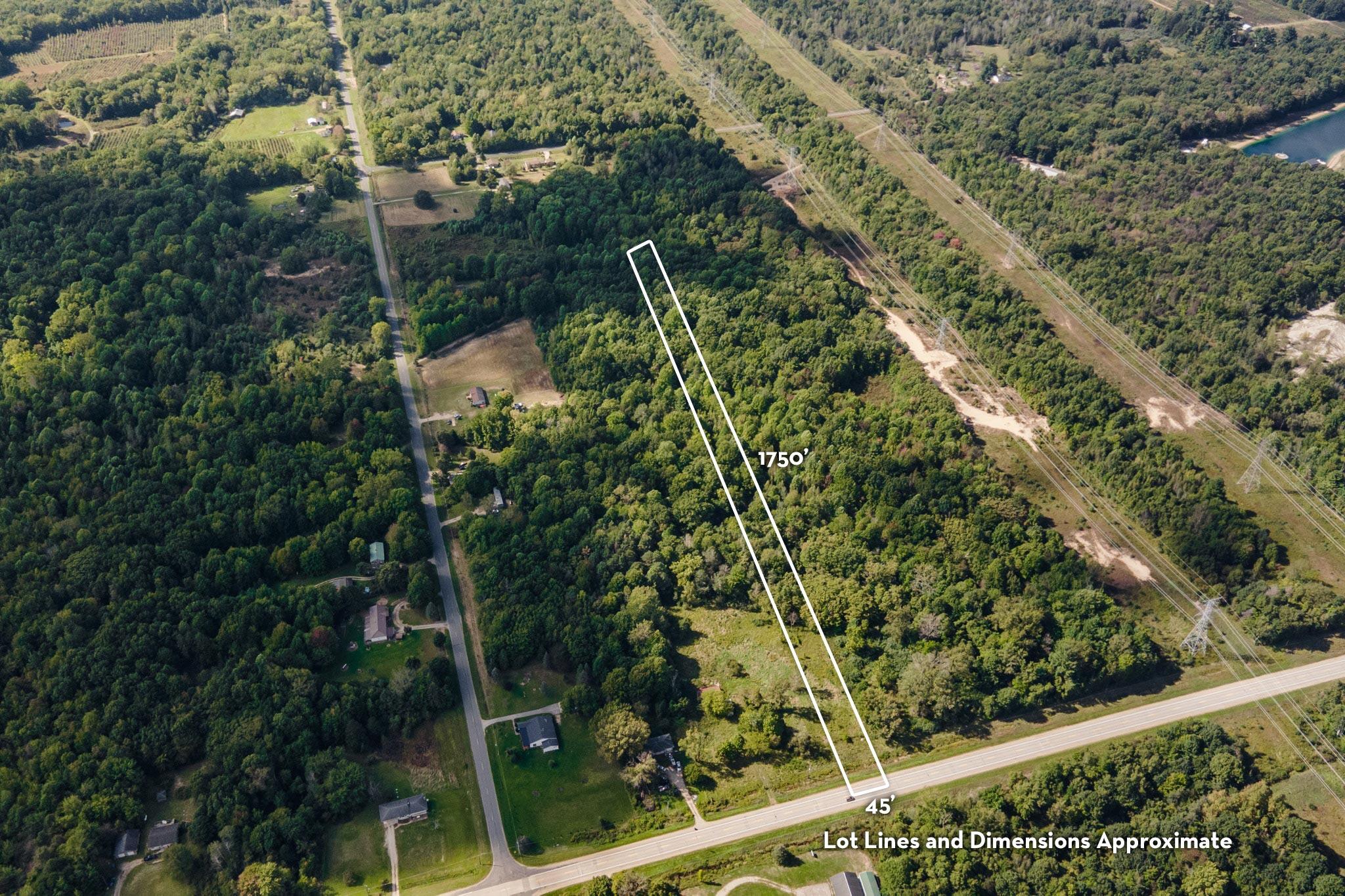 Wooded land parcel outlined from a road, with approximate dimensions marked.
