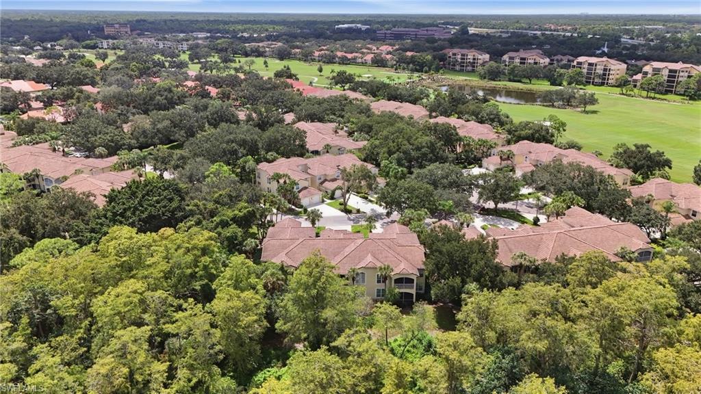Aerial view of homes beside a golf course, with landscaped fairways and mature trees.