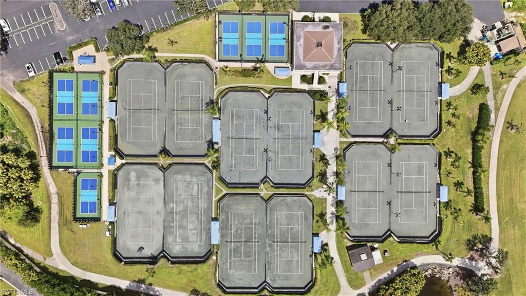 Aerial view of tennis courts arranged among lawns, trees, and walkways.