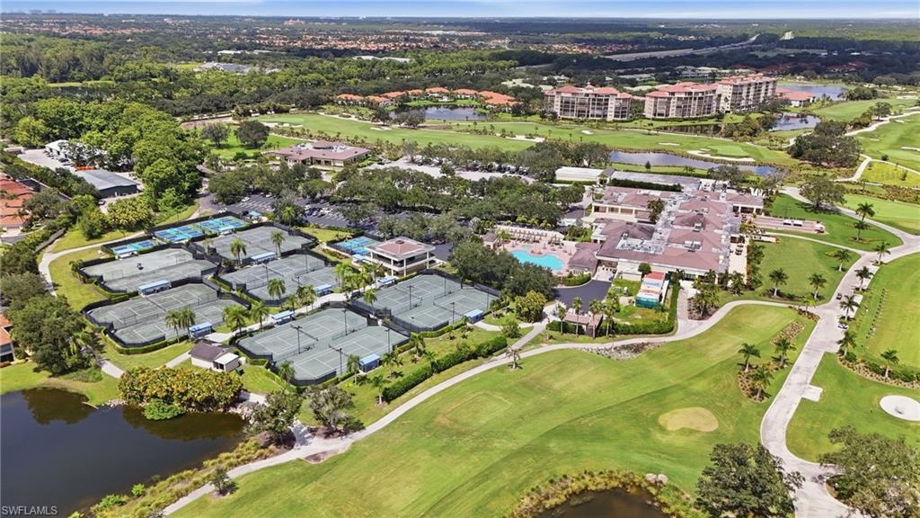 Aerial view of community golf course, tennis courts, pool, and clubhouse.