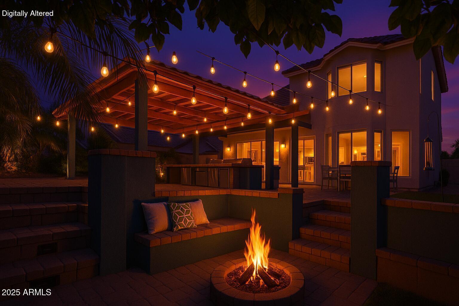 Backyard patio with a covered outdoor kitchen, string lights, built-in seating, and a circular fire pit.