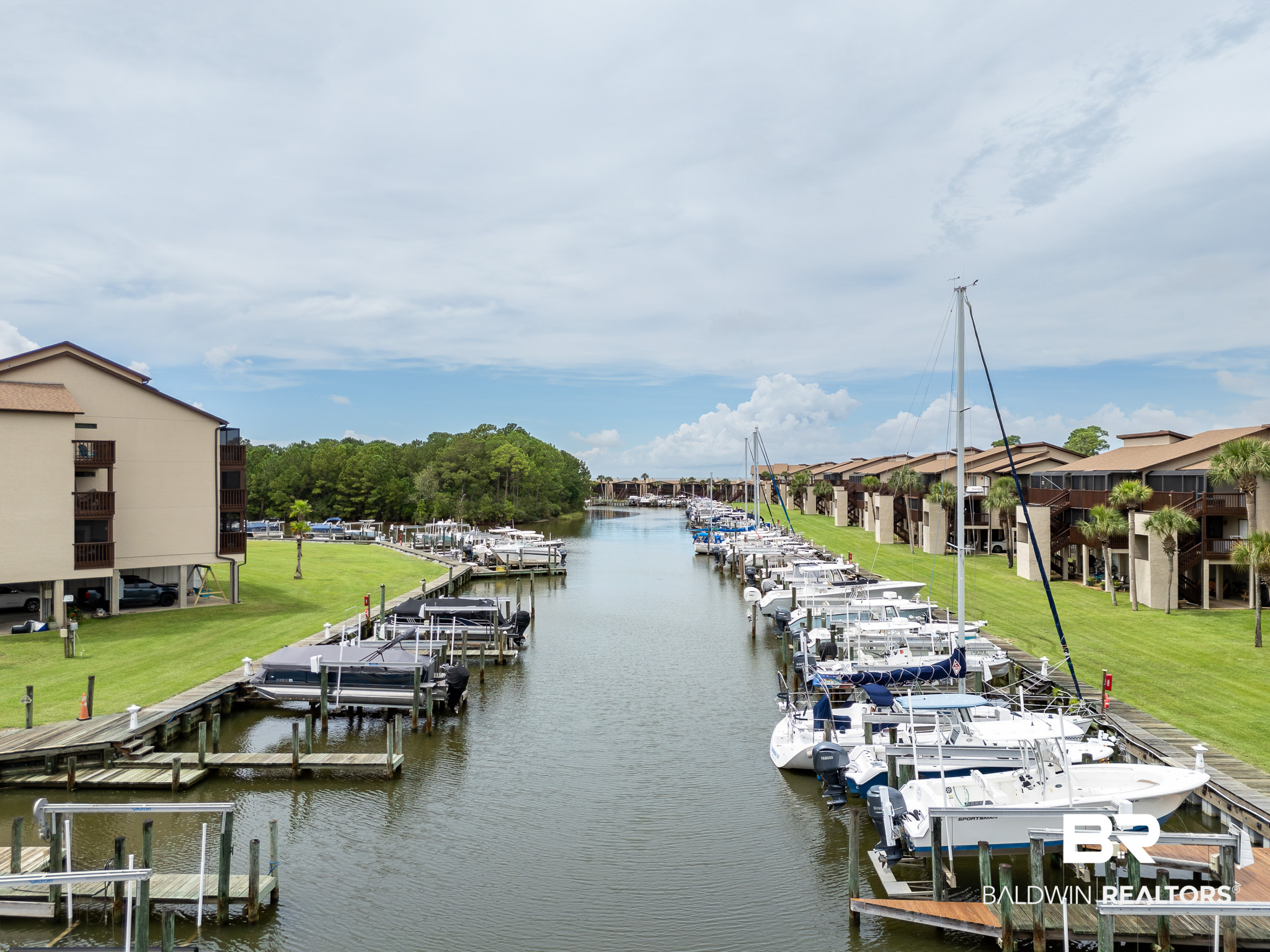 Marina canal lined with boats and waterfront condominiums.