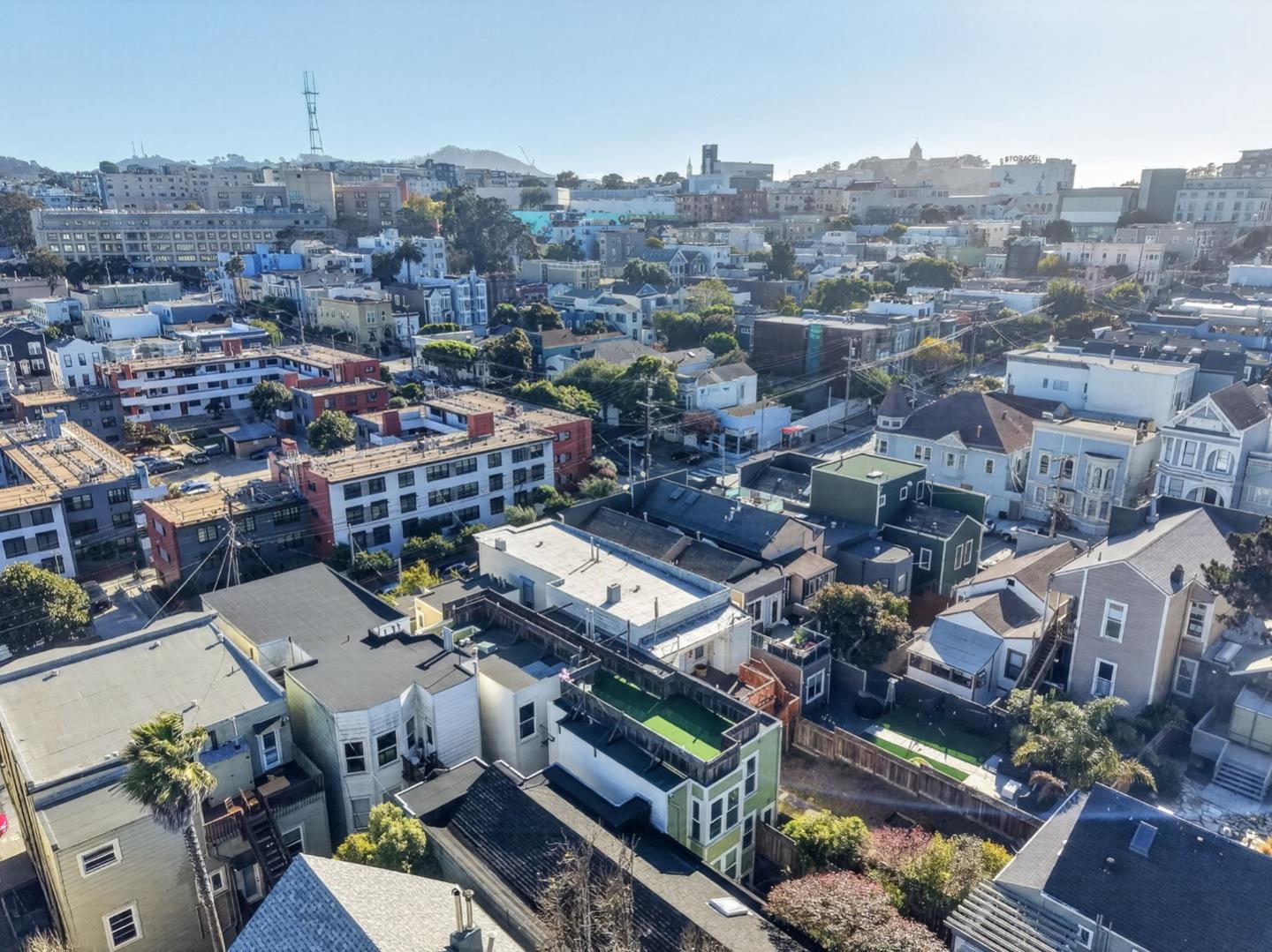 Aerial view of San Francisco rooftops, residential buildings, and a small backyard pool.