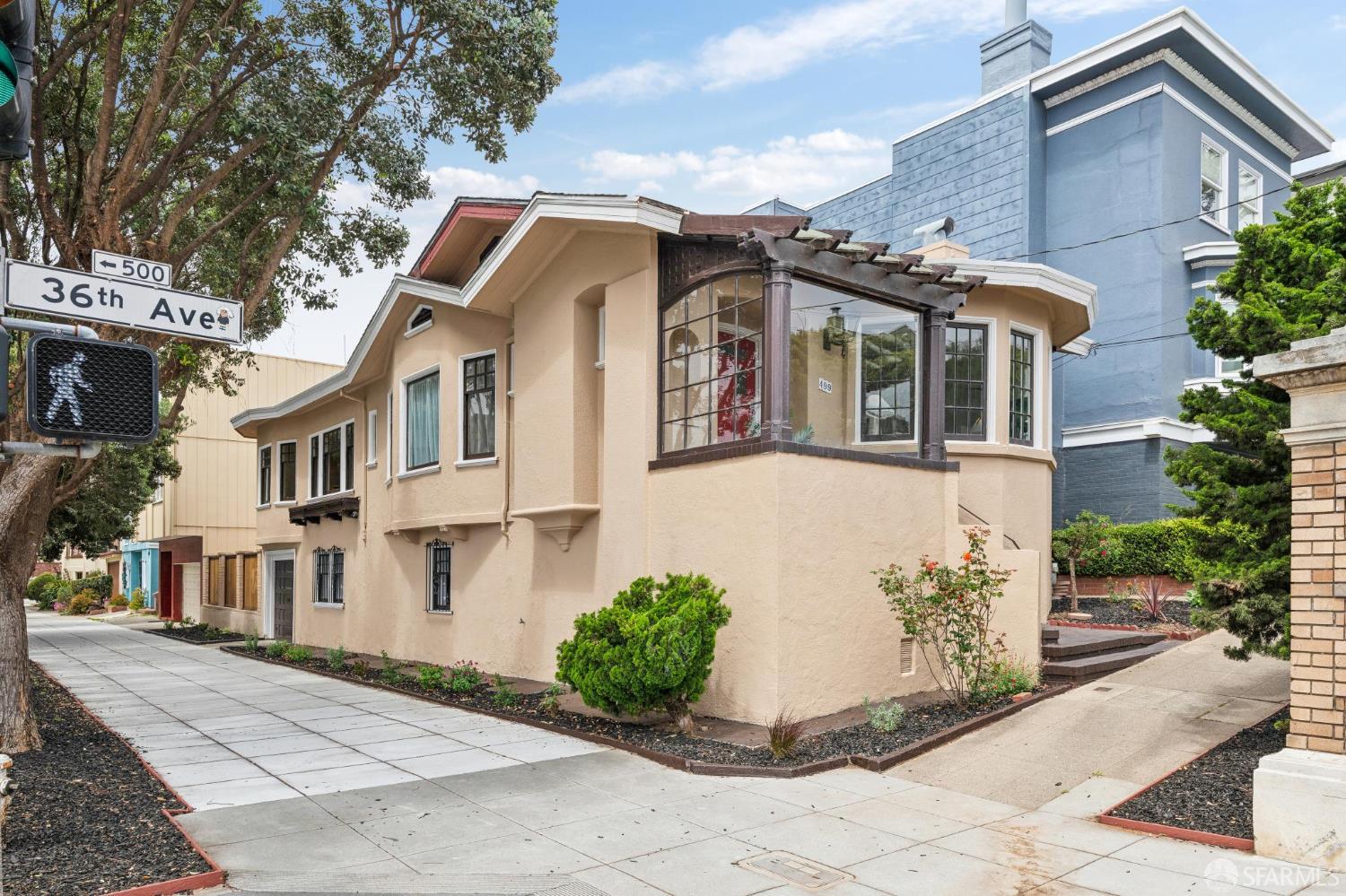 499 36th Avenue home with a beige facade and distinctive enclosed corner windows.