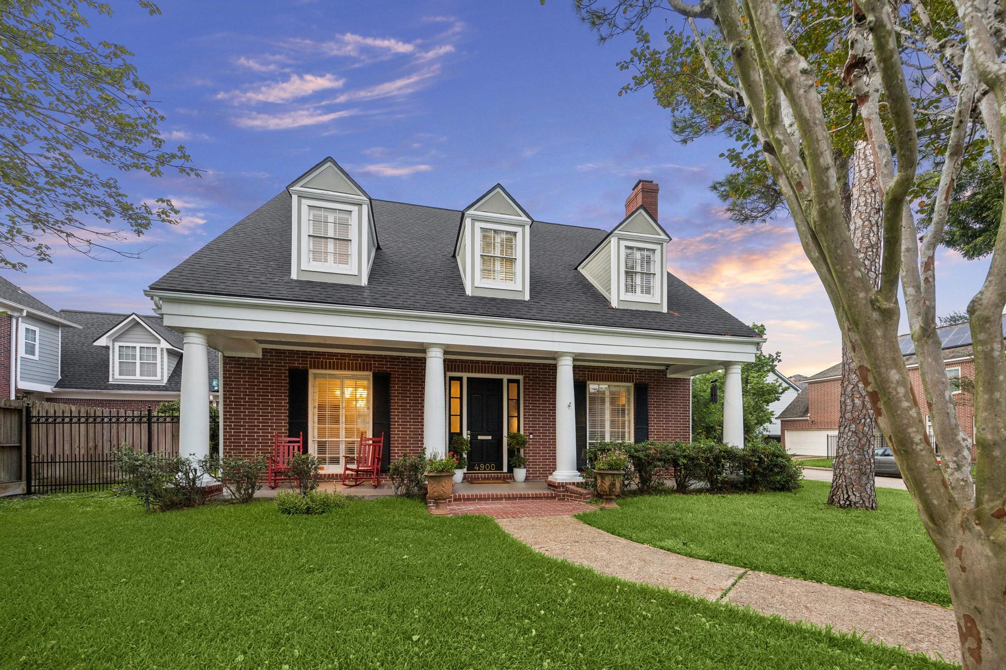 Red-brick home at 4900 Florence Street with a columned porch and three roof dormers.