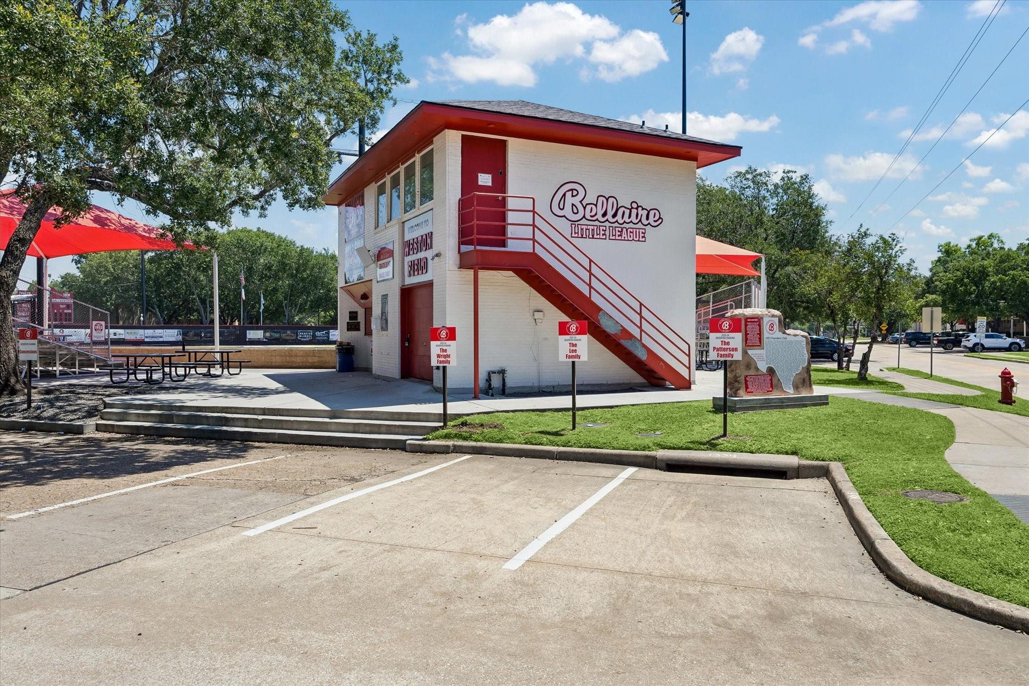 Bellaire Little League field building with red exterior stairs and covered picnic tables.