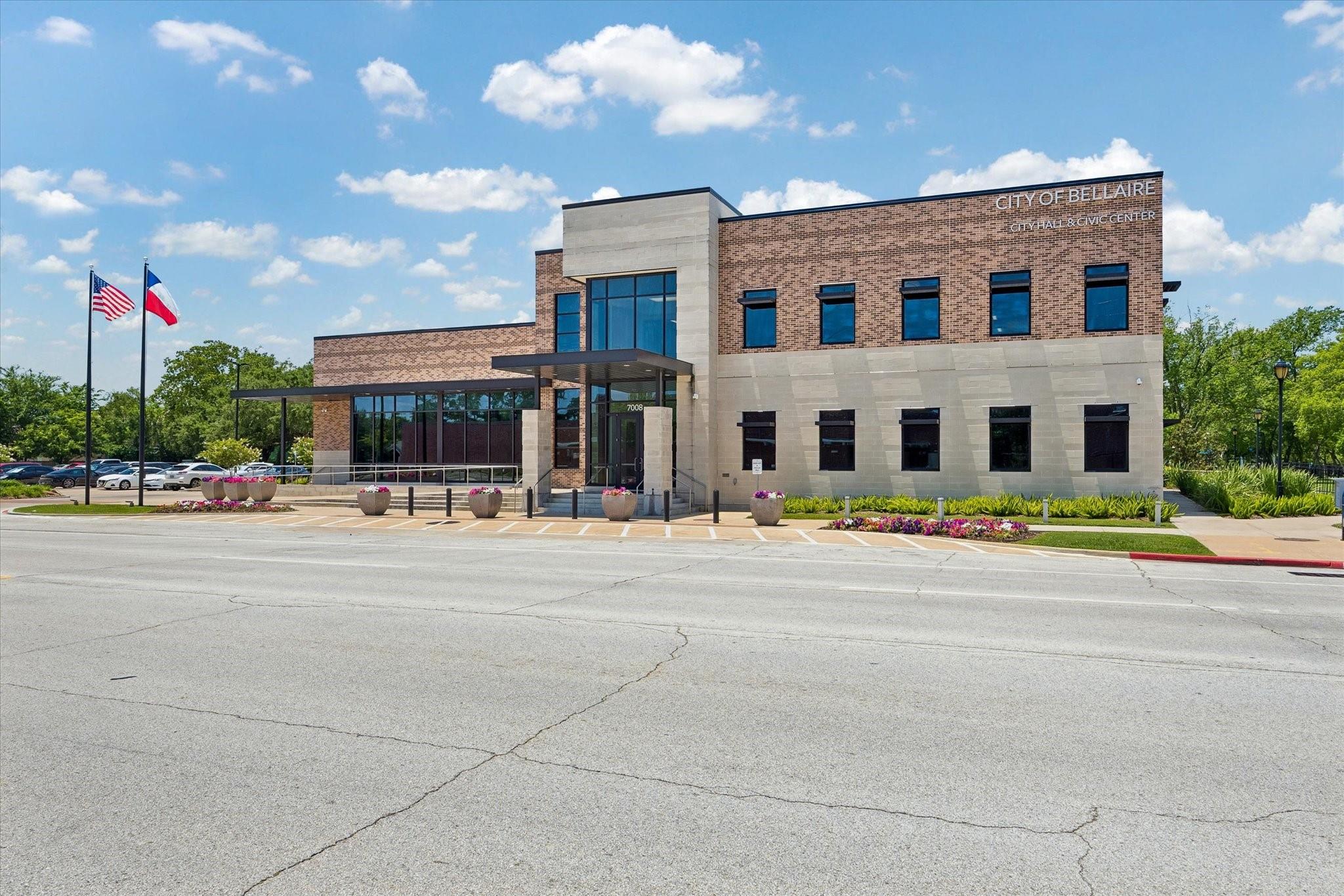 Bellaire City Hall and Civic Center, with brick and stone exterior and U.S. and Texas flags.
