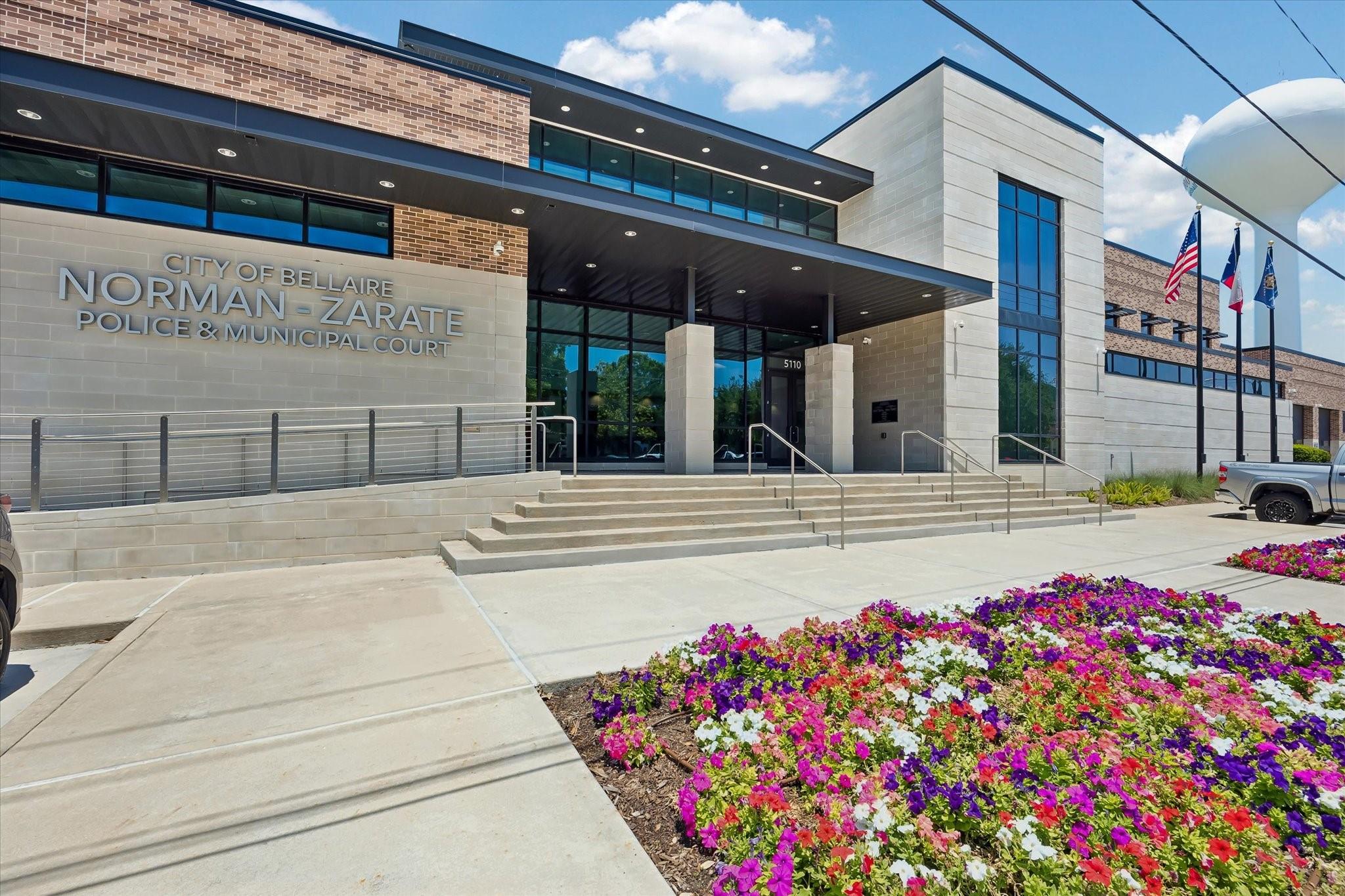 Bellaire police and municipal court building with entrance steps and a colorful flower bed.