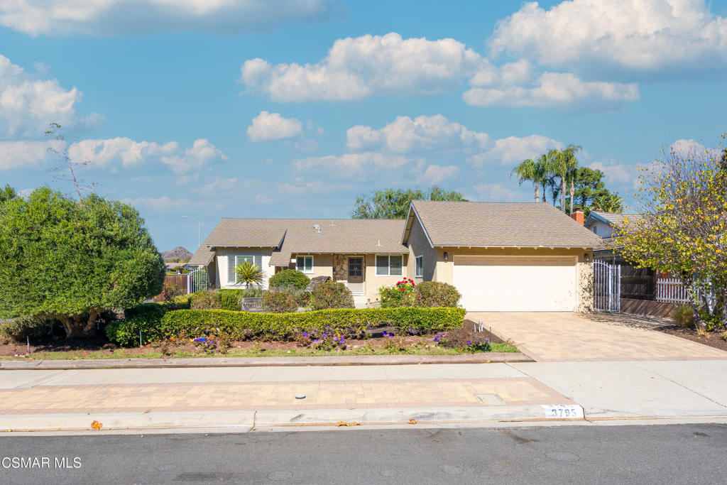 Single-story beige home with a two-car garage, landscaped front yard, and 3795 marked on the curb.