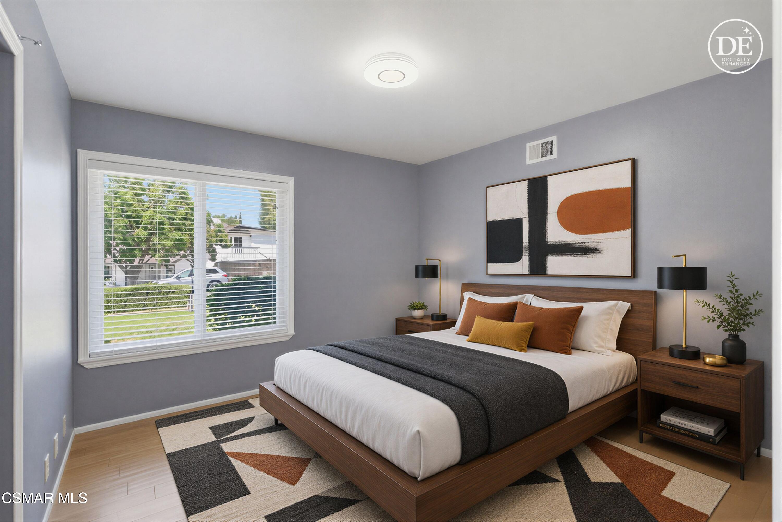 Staged bedroom with a walnut platform bed, abstract art, and a wide window with white blinds.