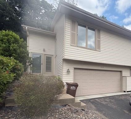 Two-story house with an attached double garage and landscaped entry.