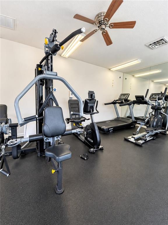 Home gym with a multi-station weight machine, treadmills, and exercise bikes.