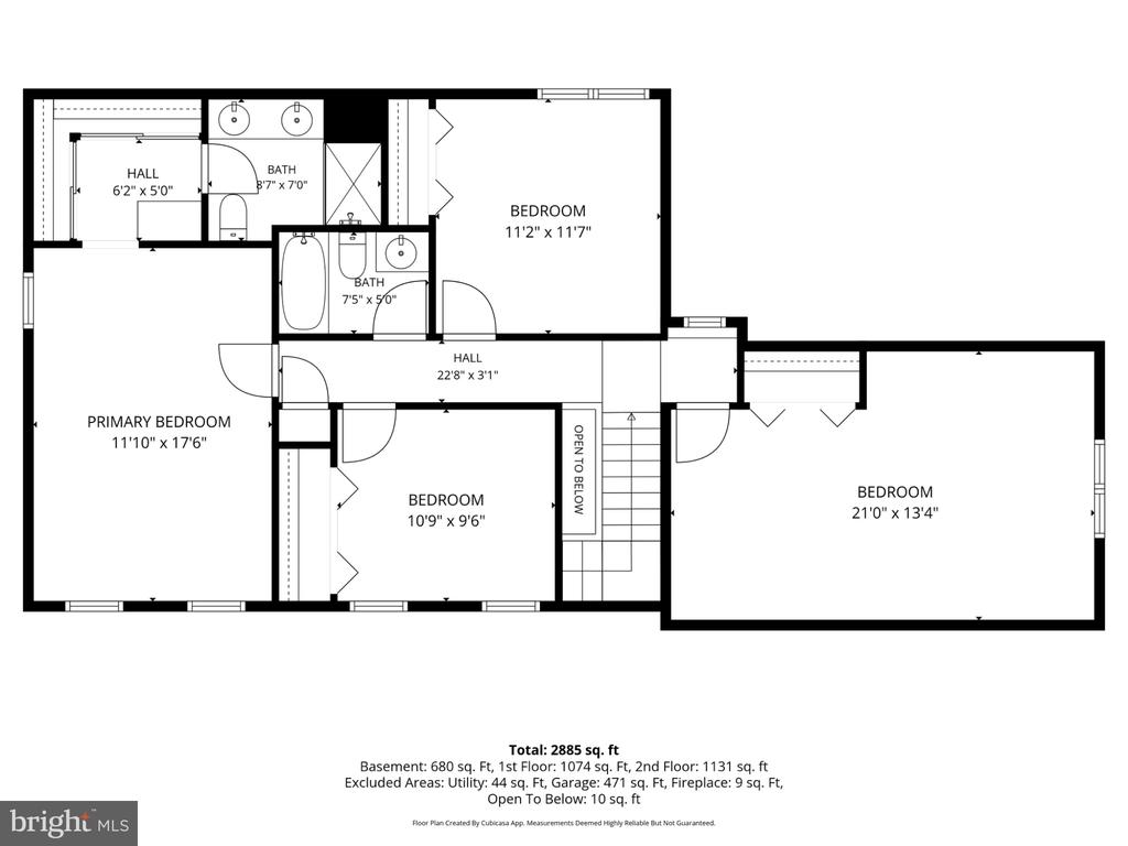 Floor plan showing four bedrooms, two bathrooms, halls, and stairs around an open-to-below area.