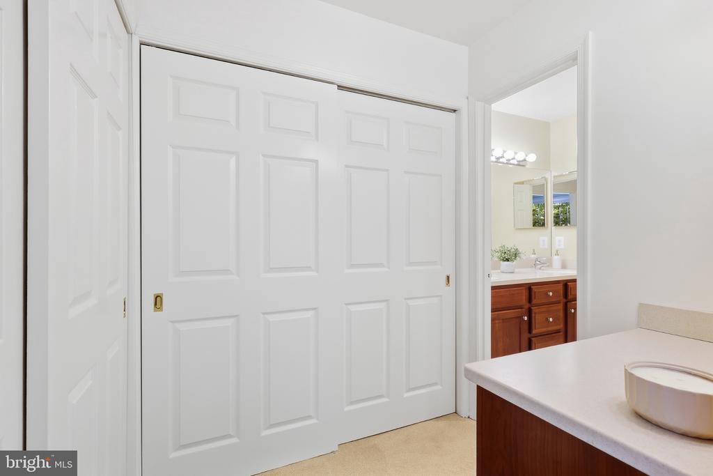 Bathroom vanity beside large white paneled sliding doors.