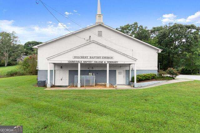 Hillcrest Baptist Church with a front steeple, covered entrance, and broad green lawn.