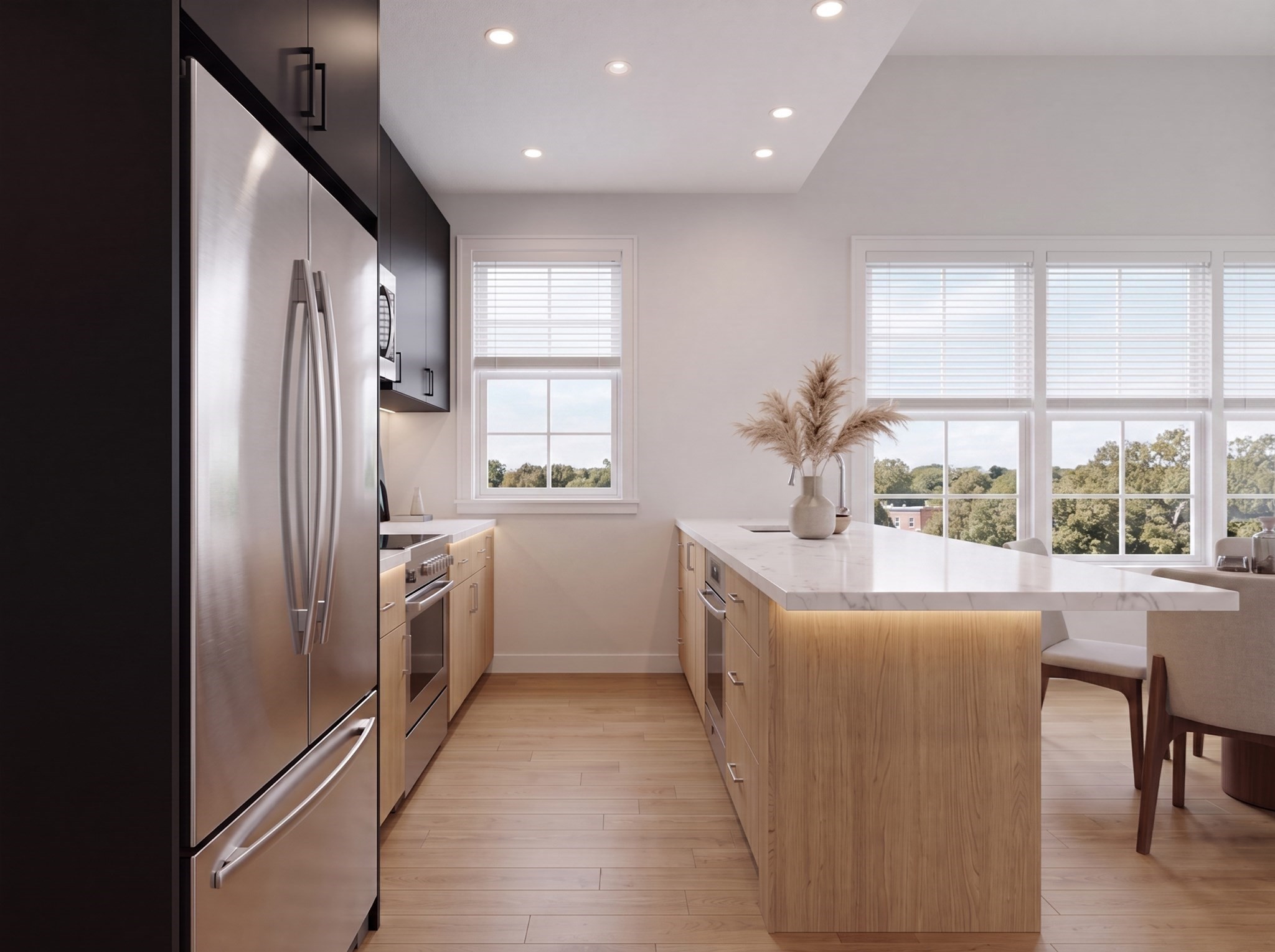 Modern kitchen with a marble-topped wood island, stainless steel appliances, and large windows overlooking trees.