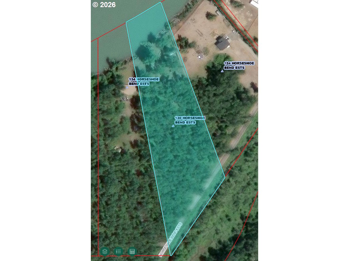 Aerial view of the wooded 130 Horseshoe Bend Estates parcel, outlined in cyan beside a waterway.
