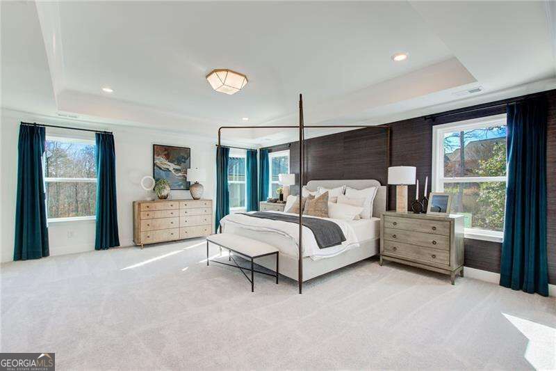 Staged bedroom with a four-poster bed, dark wood accent wall, and teal curtains.