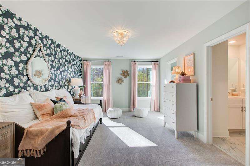 Bedroom with a dark floral accent wall, blush bedding, pink curtains, and a crystal ceiling light.