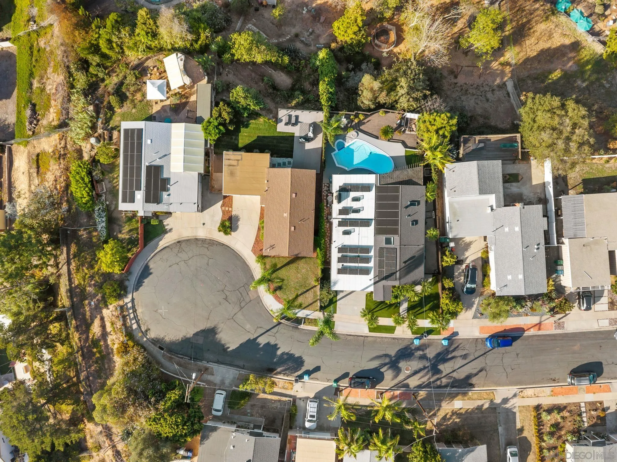 Aerial view of 3628 Arlington St with rooftop solar panels and a backyard pool.