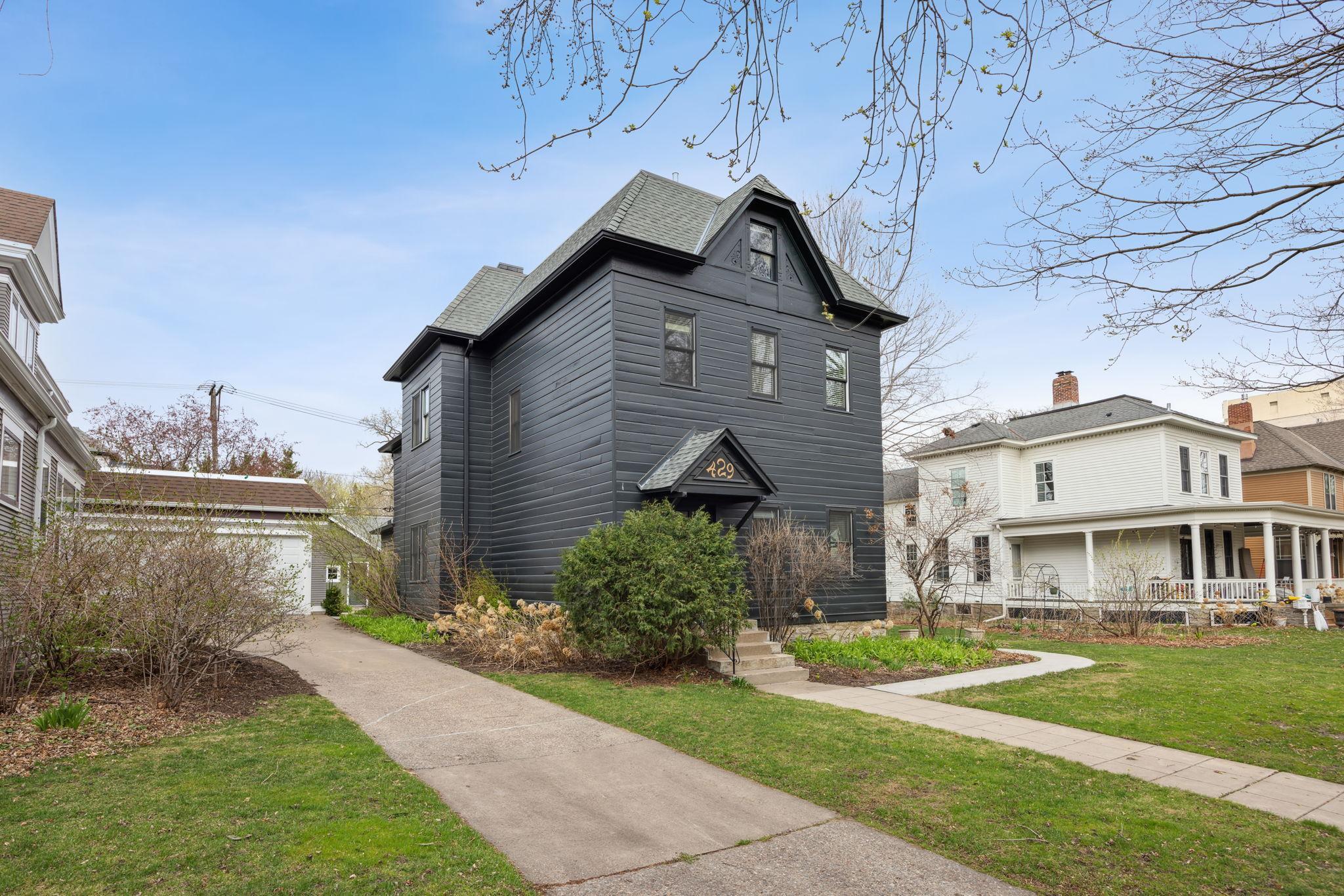 Dark gray two-story house with steep gables, marked 429 above the entrance.