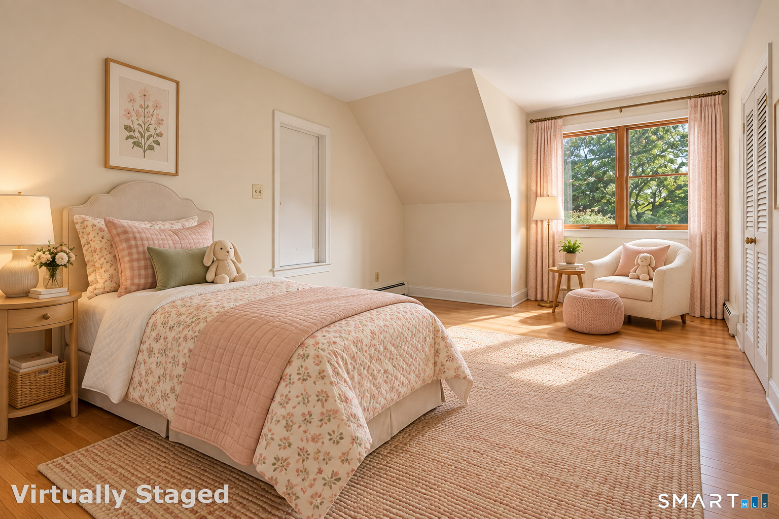 Bedroom with pink floral bedding and a white armchair beside a sunny window.